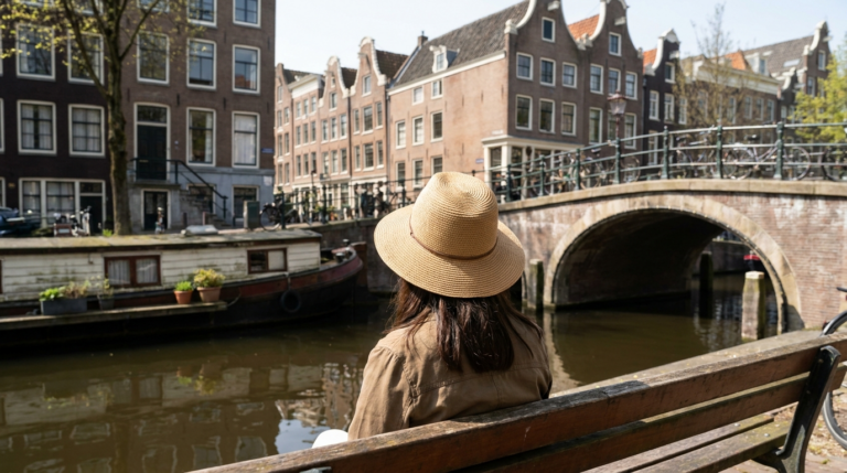 raveler looking out over an Amsterdam canal